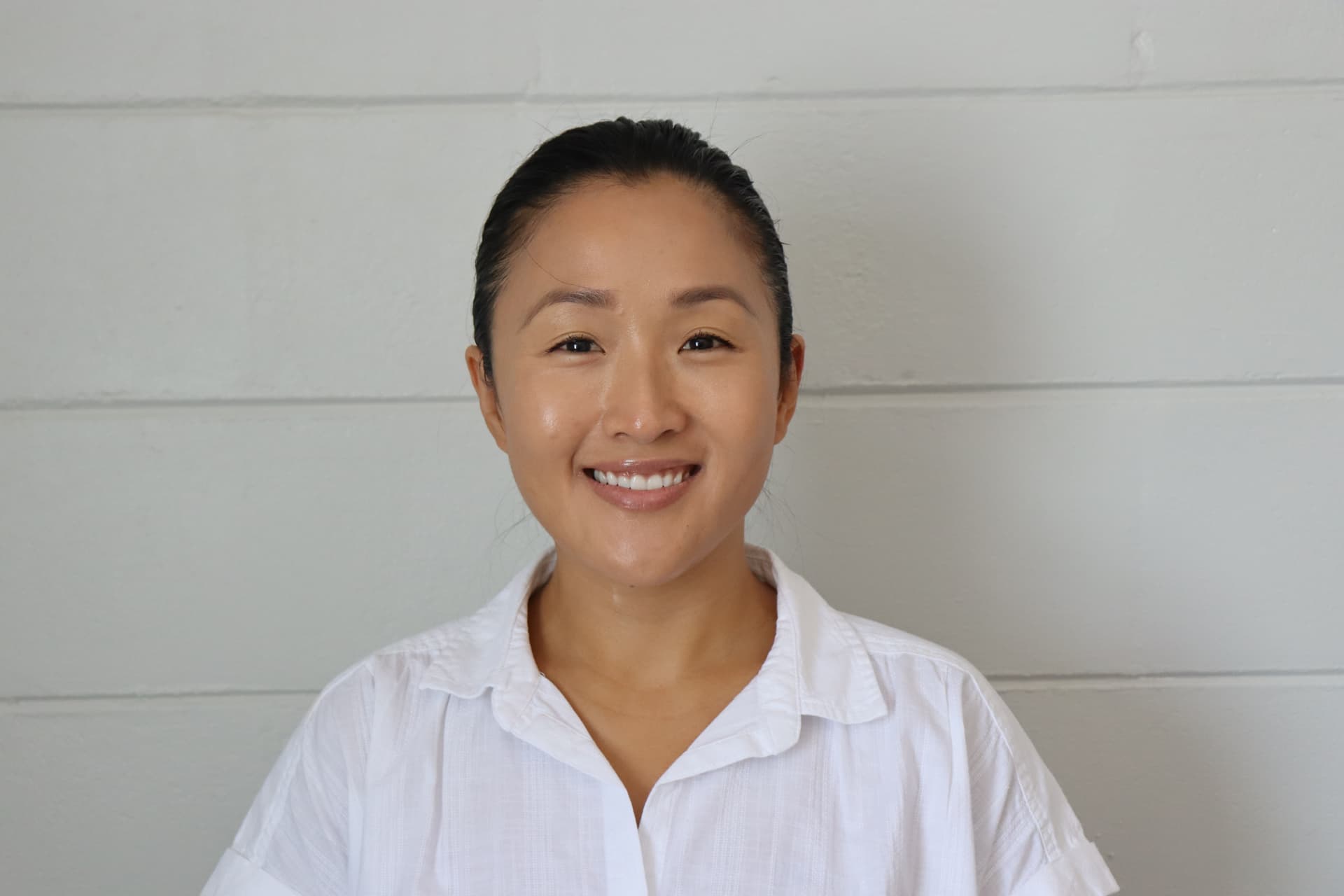Portrait of Dr. Natalie Agudo, DPT, founder and owner of Agudo Shockwave